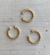 Manschette mit goldenen Kugeln